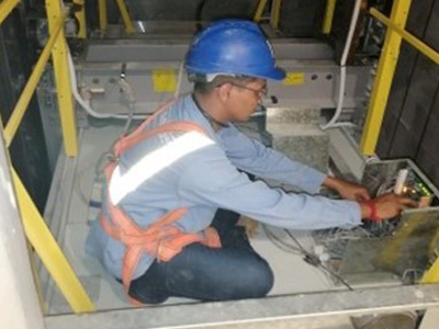 A technician working in the elevator shaft