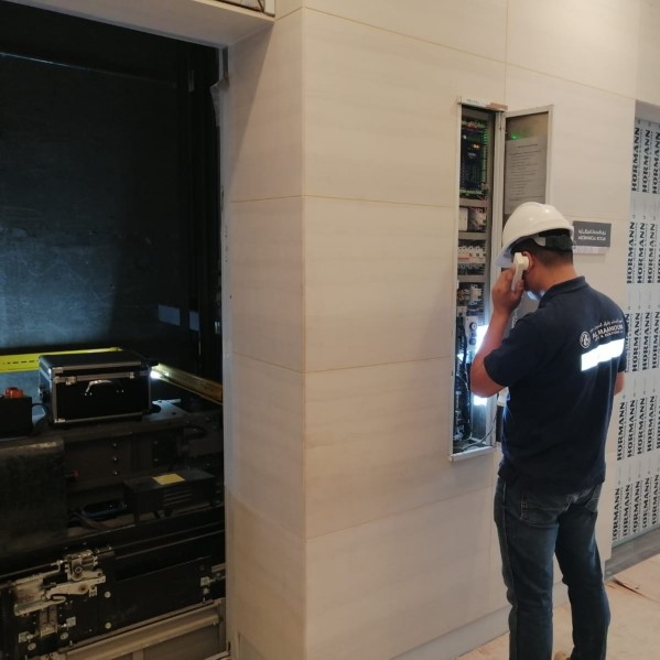 Al Maamoura technician checking the elevator control cabinet